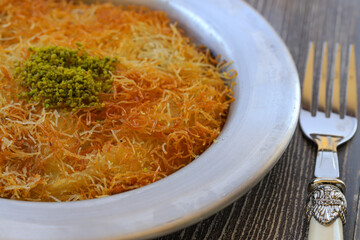 Delicious traditional Turkish kunefe with pistachio on it. Served hot and with syrup