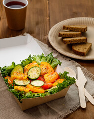 fresh vegetable salad with tomatoes and cucumber on wooden background