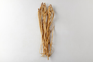 Astragalus root on a white background
