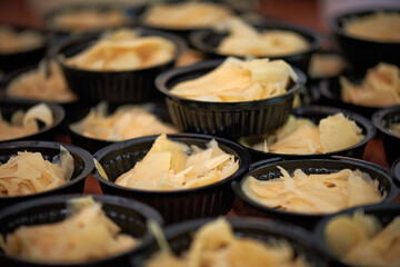 Preserved ginger in plastic plates in several rows in the restaurant's kitchen