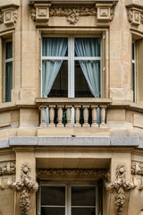 Old French house with traditional balconies and windows. Paris, France.