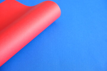 Red cardboard on a blue background. The texture of the cardboard.