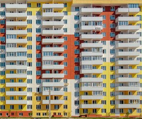 Fototapeta na wymiar Facade of a modern yellow multi-storey residential building . High quality photo