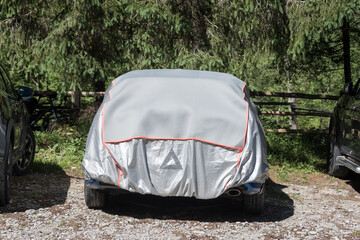 Must-have car accessories in summer - the gray and silver sun protection car cover with orange...