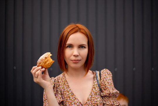 Woman 40 Years Old Eating A Bun