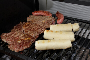 Ancho steak barbecue with sausage and garlic bread. Typical Brazilian barbecue. Steak Against Filet.