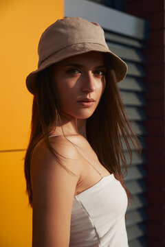 Confident woman in summer hat looking at camera