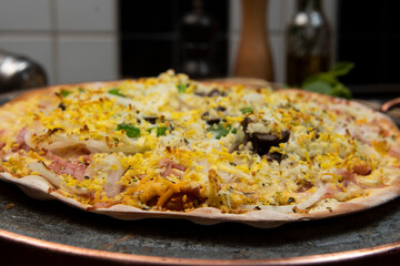 Brazilian Portuguese-style pizza with ham, egg, pepper, onion, mozzarella