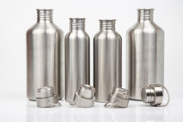 Steel flasks for water and drinks on a white background. Survival hiking gear