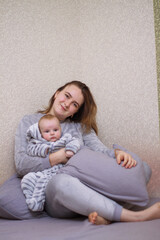 home photos of a young mother with a small child. Newborn boy. Cute, cozy photos with a baby.