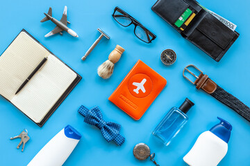 Male traveler outfit and accessories for vacation. Layout top view