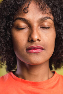 Portrait of a girl with afro style with closed eyes.
