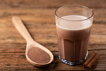 Glass with chocolate on the table.