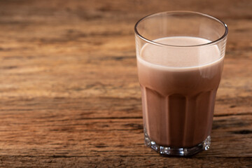 Glass with chocolate on the table.