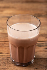Glass with chocolate on the table.