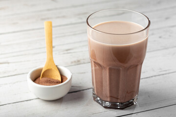Glass with chocolate on the table.