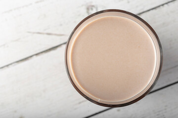 Glass with chocolate on the table.