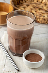 Glass with chocolate on the table.