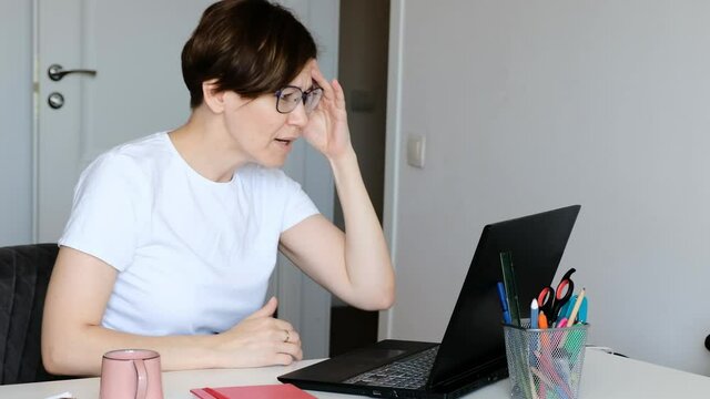 Confused young caucasian woman reading email on computer, feeling angry and depressed of getting bad news online, receiving dismissal notice, lost job concept.