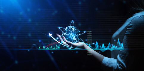 Businesswoman holding globe with network connection and graph data  exchanges. Business network technology and modern  innovation.