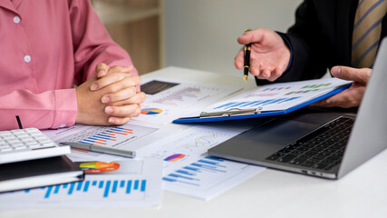 Close up of marketing manager employee pointing at business document,Brainstorming stock market investment plans,With statistical data showing profits and income teamwork concept.