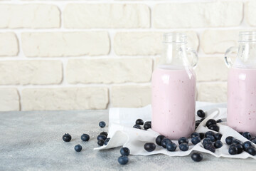 Studio shot of one blueberry milkshake glass. Single protein shake drink with berries isolated on white background. Clean eating concept. Copy space for text, close up, top view