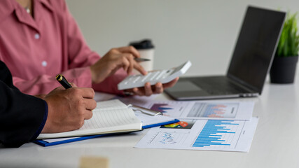 Fototapeta premium Close up of marketing manager employee pointing at business document,Brainstorming stock market investment plans,With statistical data showing profits and income teamwork concept.