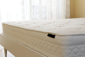 White orthopedic mattress top side surface pattern on unmade bed in the bedroom. Hypoallergenic...