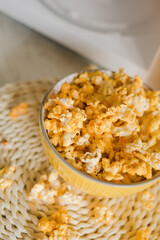 Popcorn is taken out of the microwave in the kitchen.