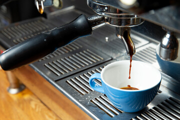 The coffee machine pours coffee into the cup.