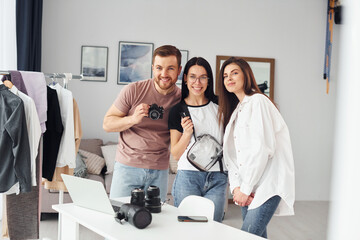 Preparing model. Photographers works indoors in their studio at daytime