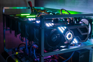Rig of six video cards. Cryptocurrency concept. gpu render farm. Mining background. Neon LED...
