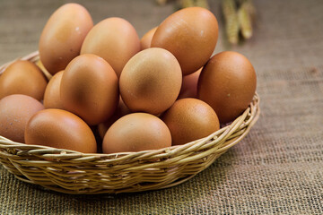 closeup chicken eggs in a wicker basket isolate on the table