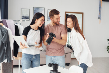 Preparing model. Photographers works indoors in their studio at daytime