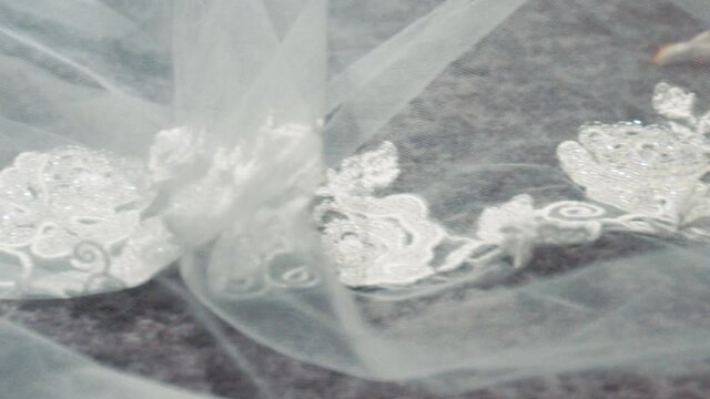 Wedding dress lace train sits along the floor 