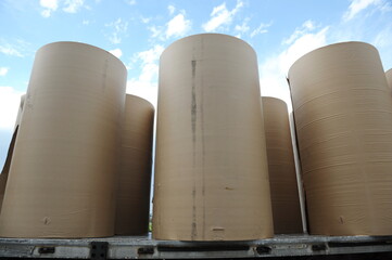 Almaty, Kazakhstan - 07.01.2016 : Large rolls of cardboard are delivered by special equipment on the territory of the plan