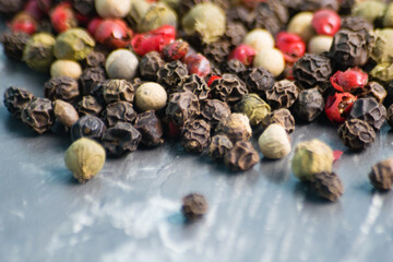 Mix of peppers peas on a dark background, close-up with blur foreground, copy space