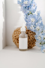 Serum and natural sponges on a light background.