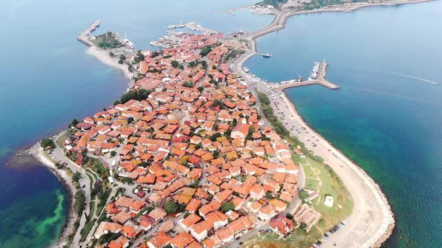 Ancient town of Nessebar aerial view. Drone flies over tiled roofs of houses. UNESCO heritage.
