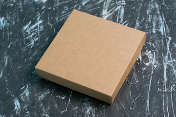 Brown craft box on a dark gray background. Gift selection concept