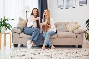 Talking to each other. Young mother with her daughter is at home at daytime