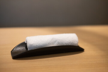 Rolling up white towel for hand wiping