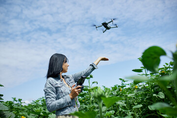 Young woman learning how to pilot her drone in, female using, piloting