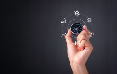 Business navigate concept, Hand holding compass navigation for guide to recovery business planning growth in the economic crisis and trading graph financial data, action plan icon.