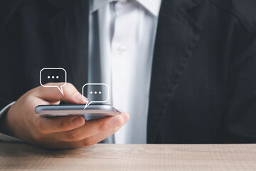 Live Chat on Communication social network Concept.  Hand using smartphone typing, chatting conversation in chat box icons pop up.