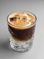 Cold drink with espresso and tonic in glass