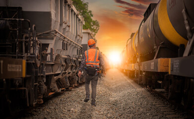 Engineer under inspection and checking construction process railway switch and checking work on railroad station .Engineer wearing safety uniform and safety helmet in work.