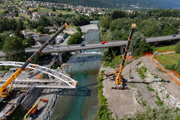 Sondrio, Italy, launch of a steel bridge over the Mallero stream, aerial view
