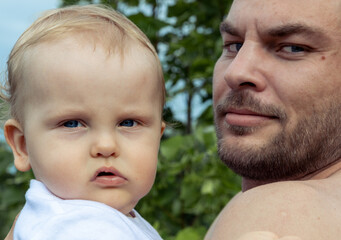 Young adult man father holding his baby on his hand.