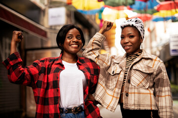Portrait of a happy smiling female friends. Beautiful african woman laughing outdoors.